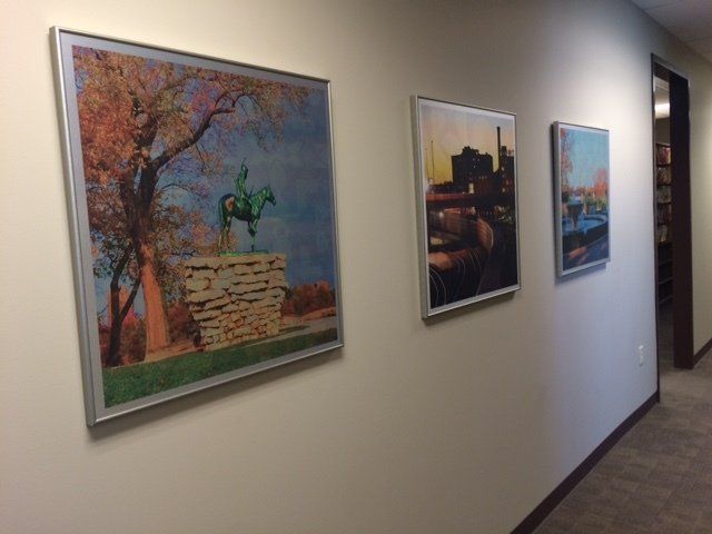 A hallway with three framed pictures on the wall