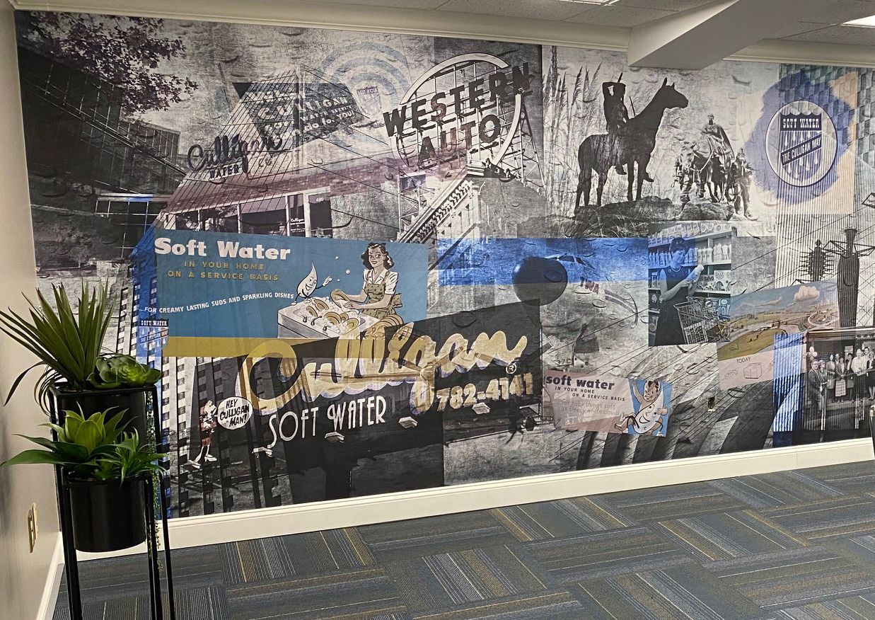 A wall with a collage of pictures and words on it.