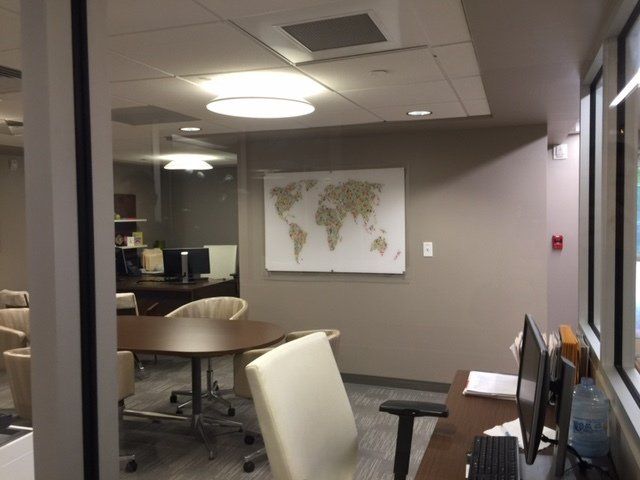 A conference room with a map of the world on the wall