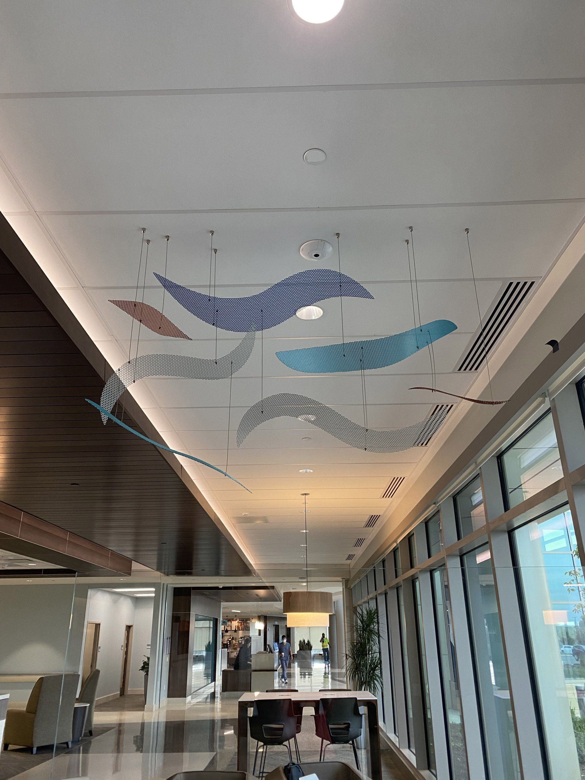 A long hallway with a ceiling that has a painting on it.