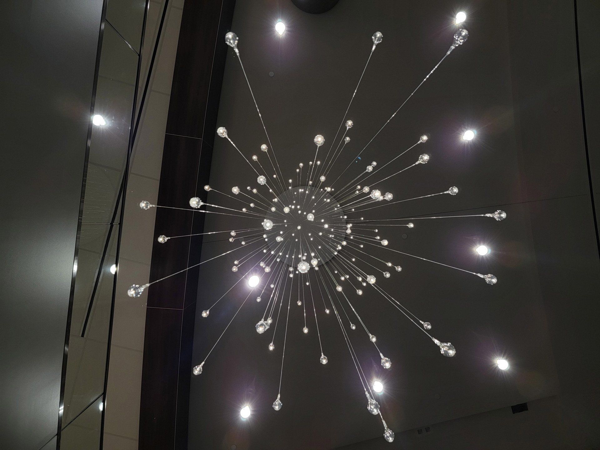 A chandelier with a lot of lights hanging from the ceiling