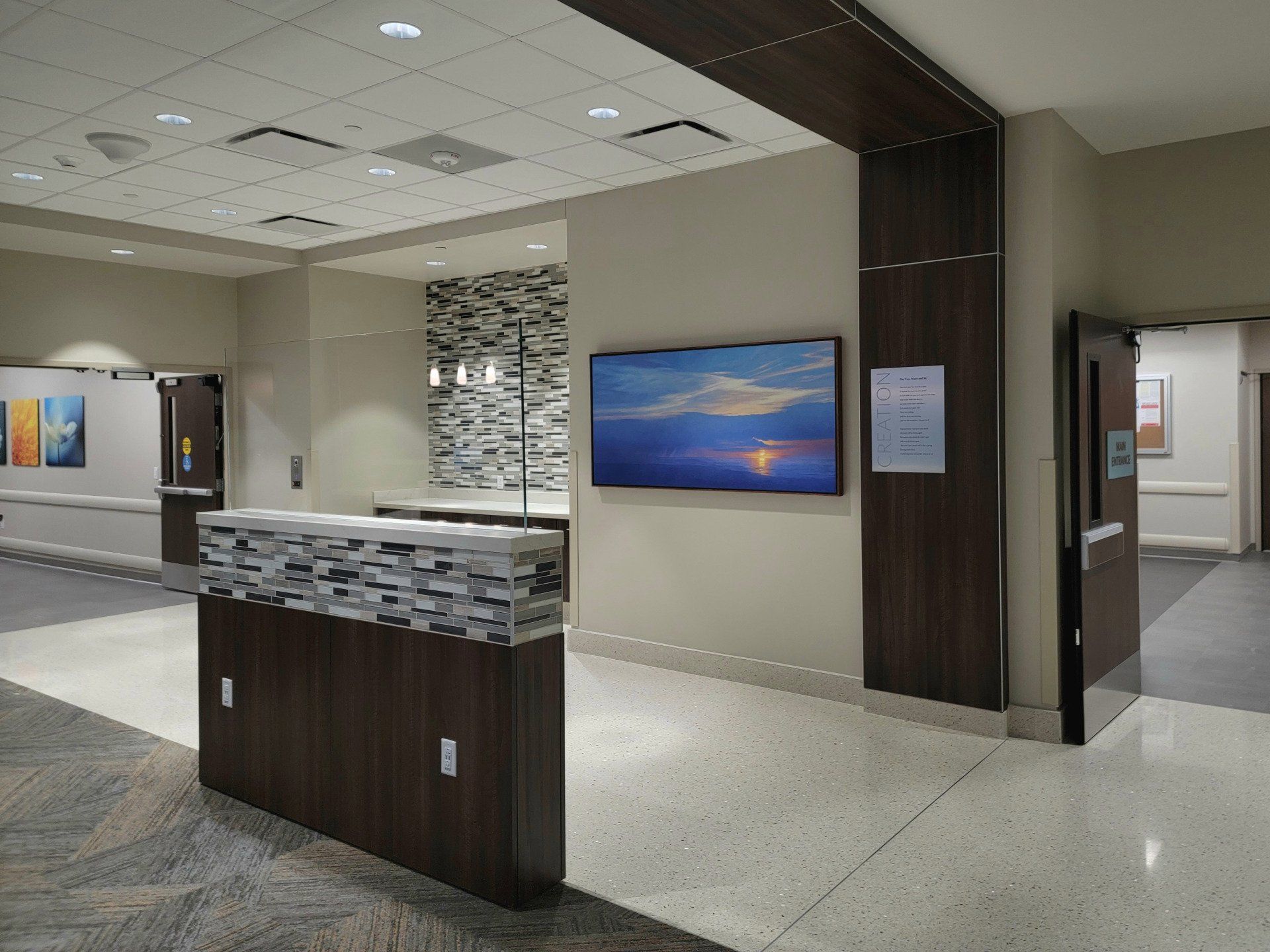 A hospital lobby with a large painting on the wall