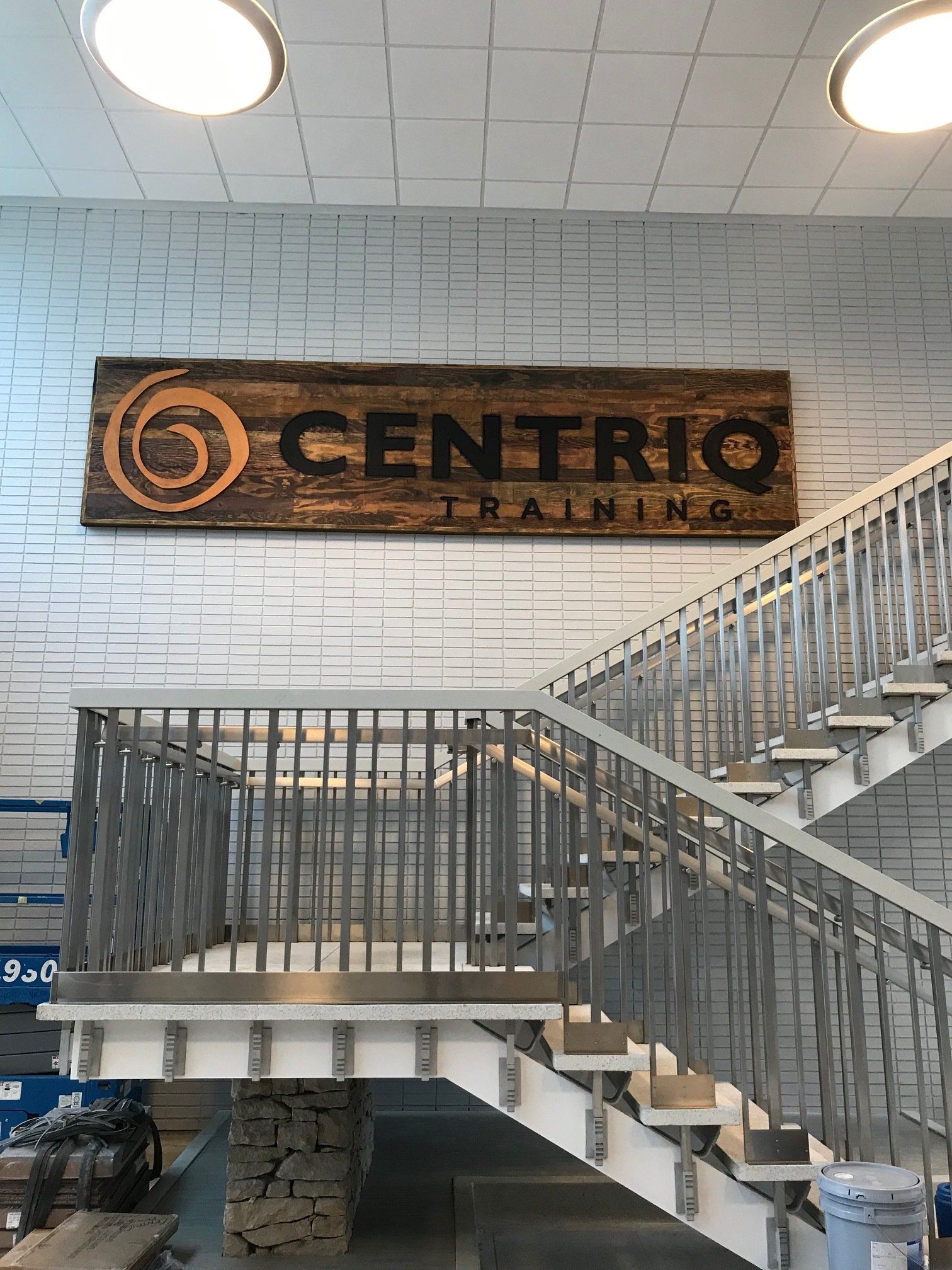 There is a sign on the wall above the stairs that says centro training.