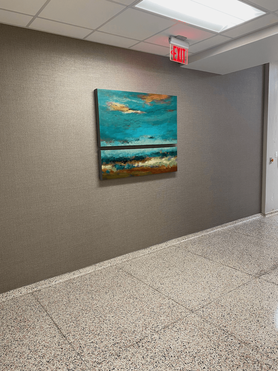 A painting is hanging on a wall in a hallway.