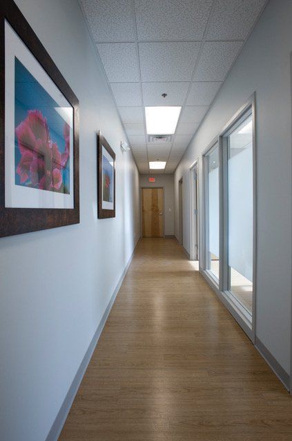 A long hallway with a few pictures on the wall