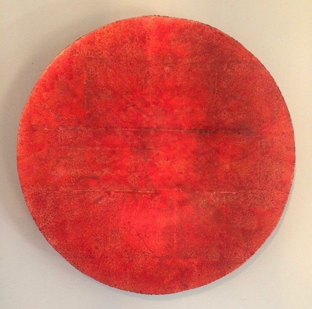 A red circle is on a white surface