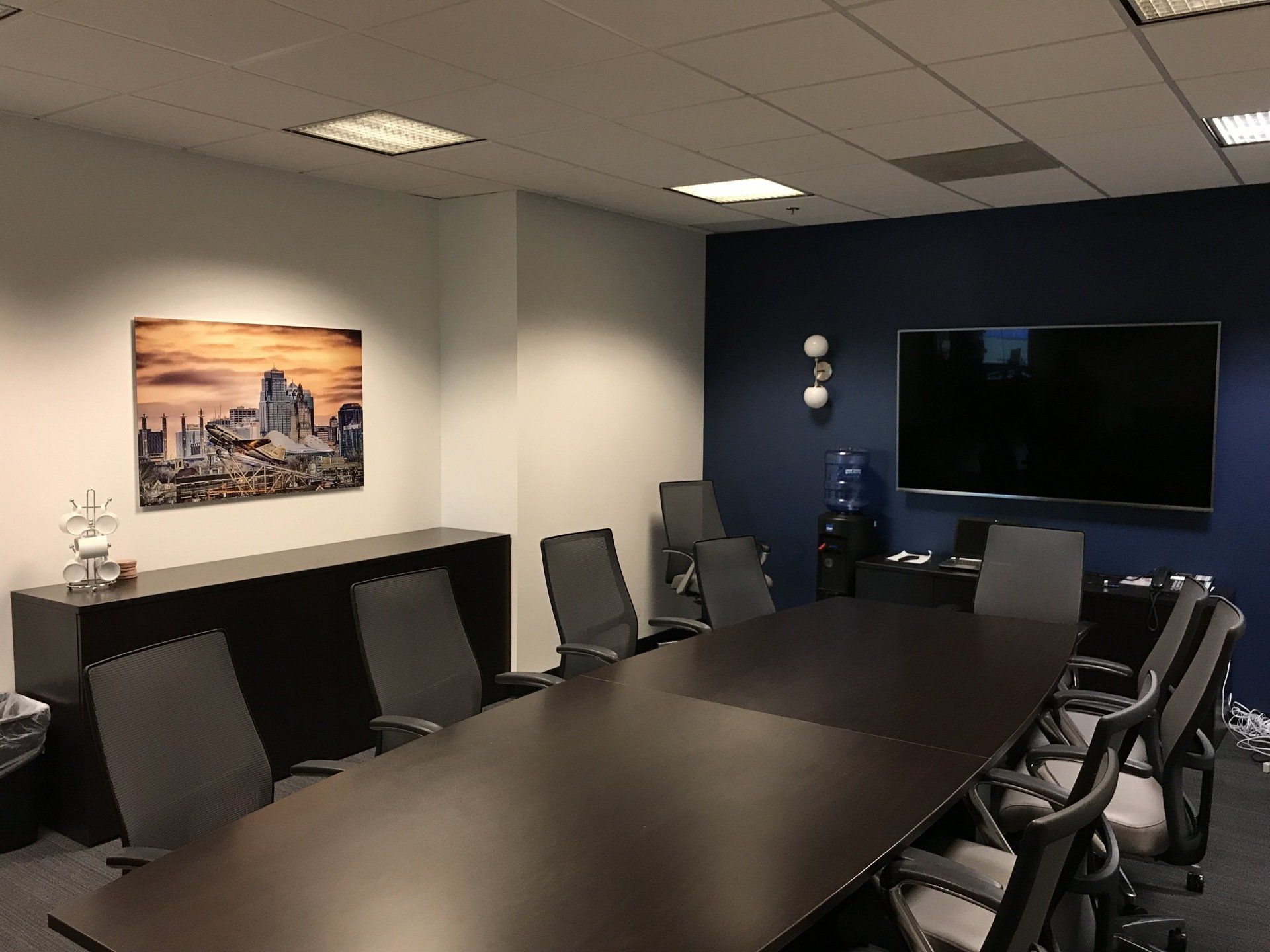 A conference room with a long table and chairs