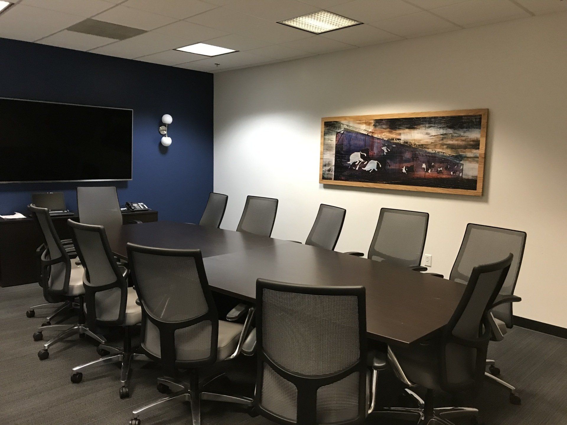 A conference room with a long table and chairs