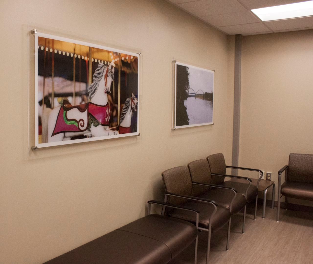 A waiting room with a picture of a merry go round on the wall