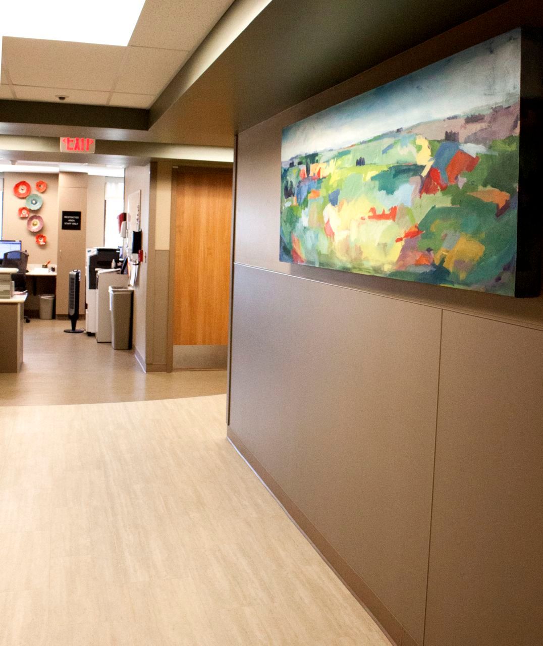 A hallway with a large painting on the wall