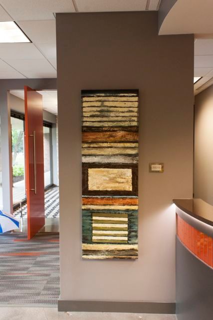 A painting is hanging on a wall in a hallway