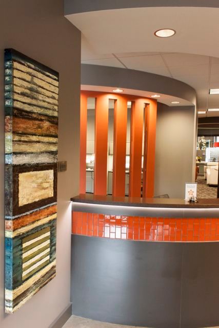 A painting hangs on a wall next to a reception desk