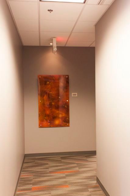 A hallway with a painting on the wall.