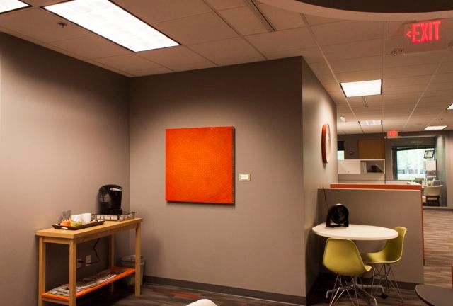 A room with a red exit sign on the ceiling