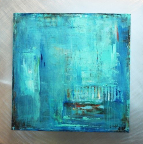 A blue painting is sitting on a metal surface.