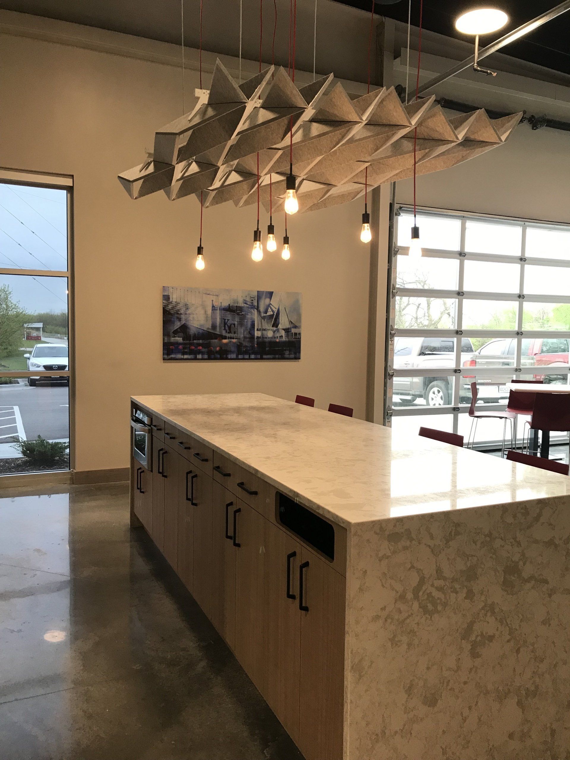 A kitchen with a large island and a painting on the wall