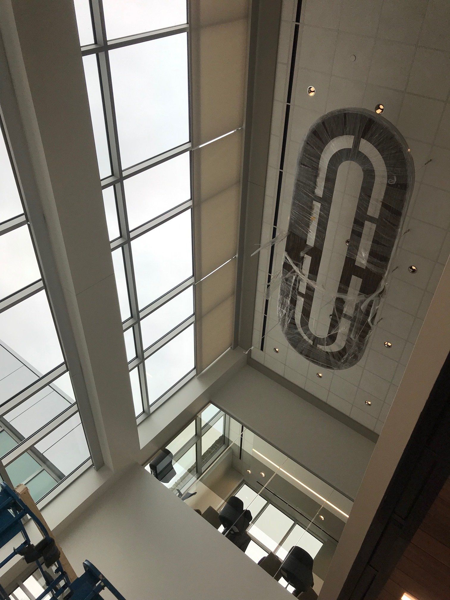 Looking up at a ceiling with a large letter c on it