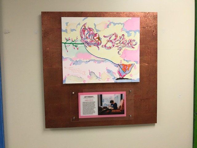 A painting with the word believe on it