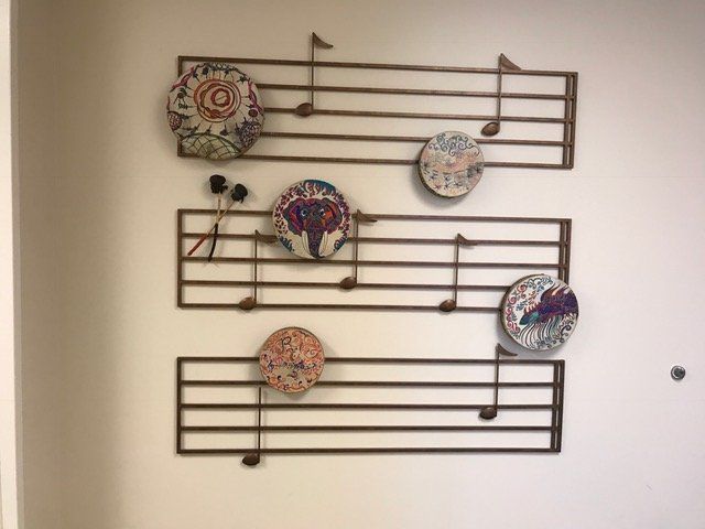 A wall with music notes and cds on it
