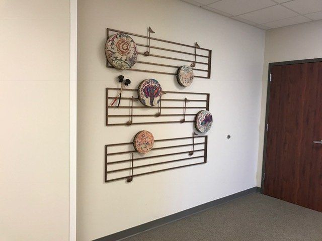 A wall with music notes on it in a hallway