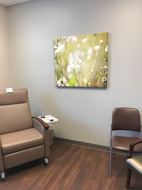 A room with chairs and a painting on the wall