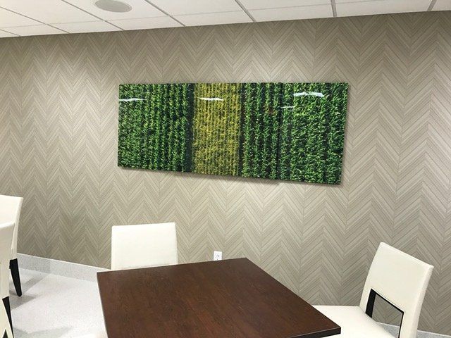 A room with a table and chairs and a painting on the wall