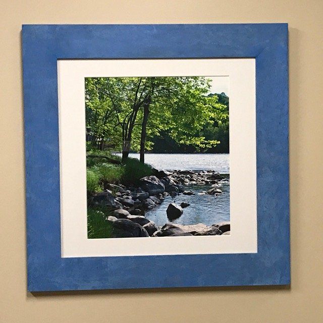 A picture of a river in a blue frame