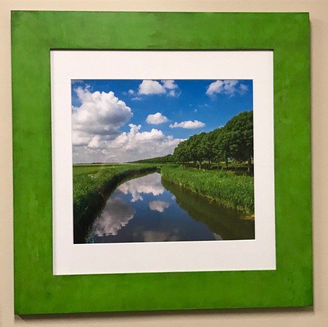 A picture of a river in a green frame