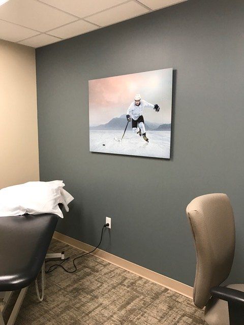 A painting of a hockey player is hanging on a wall