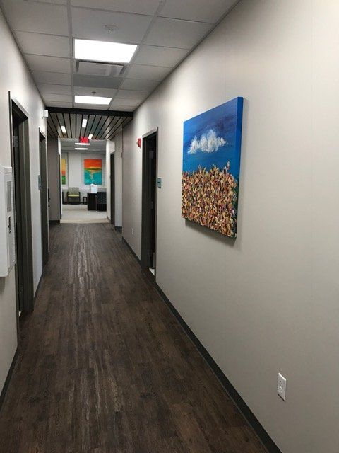 A long hallway with a painting on the wall