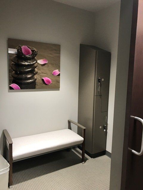 A room with a bench and a painting on the wall