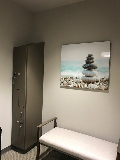 A room with a painting of rocks on the wall