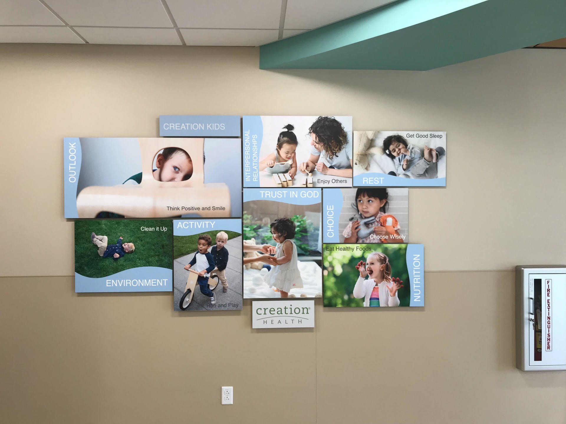 A wall with a bunch of pictures of children on it