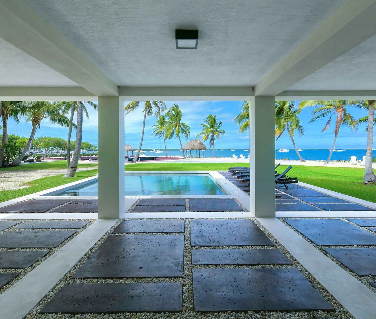 A view of a swimming pool with palm trees in the background