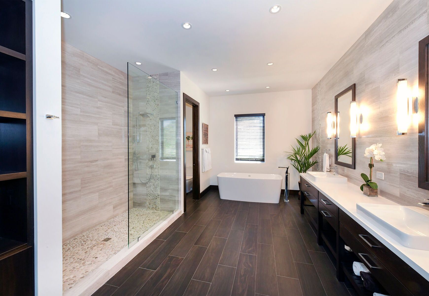 A bathroom with a tub and a walk in shower.