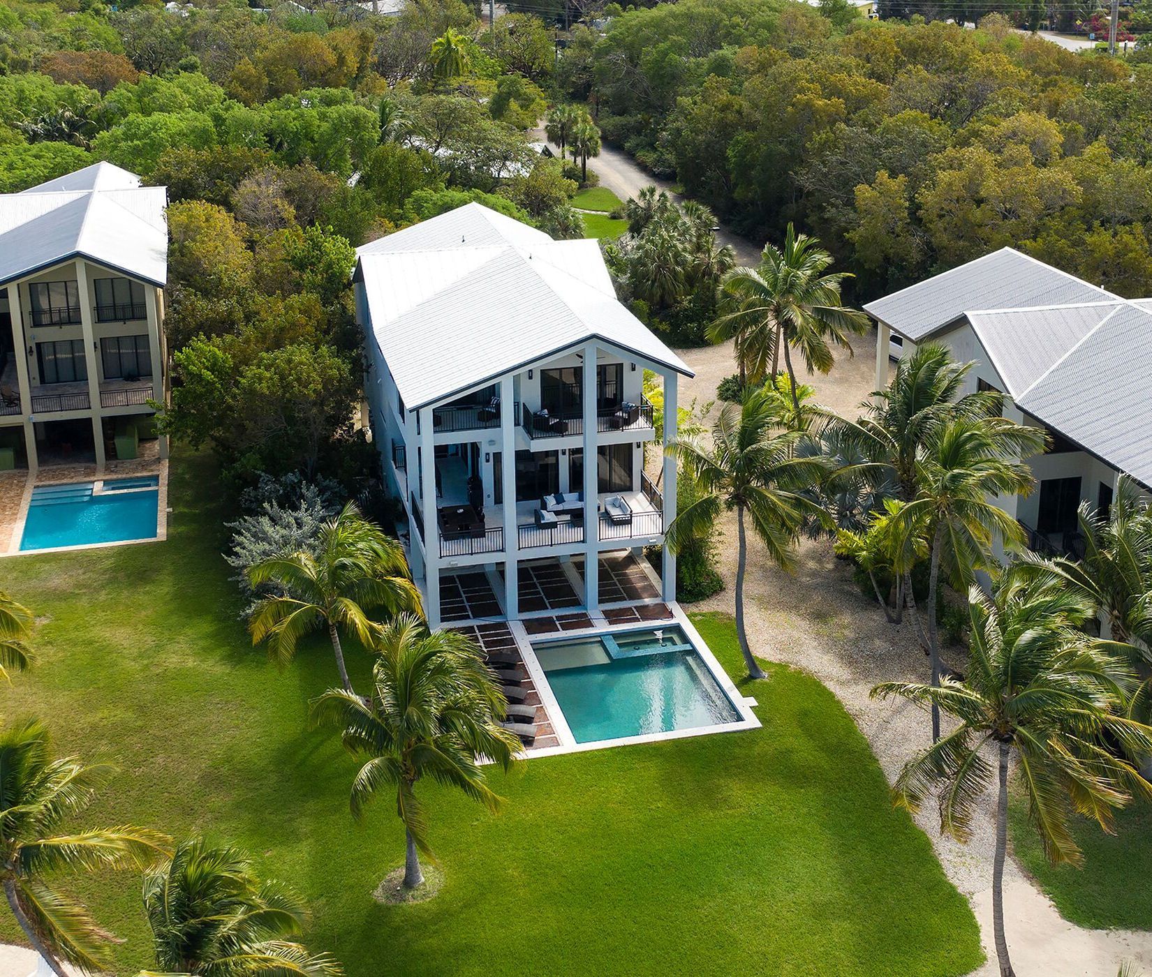 An aerial view of a house with a large pool