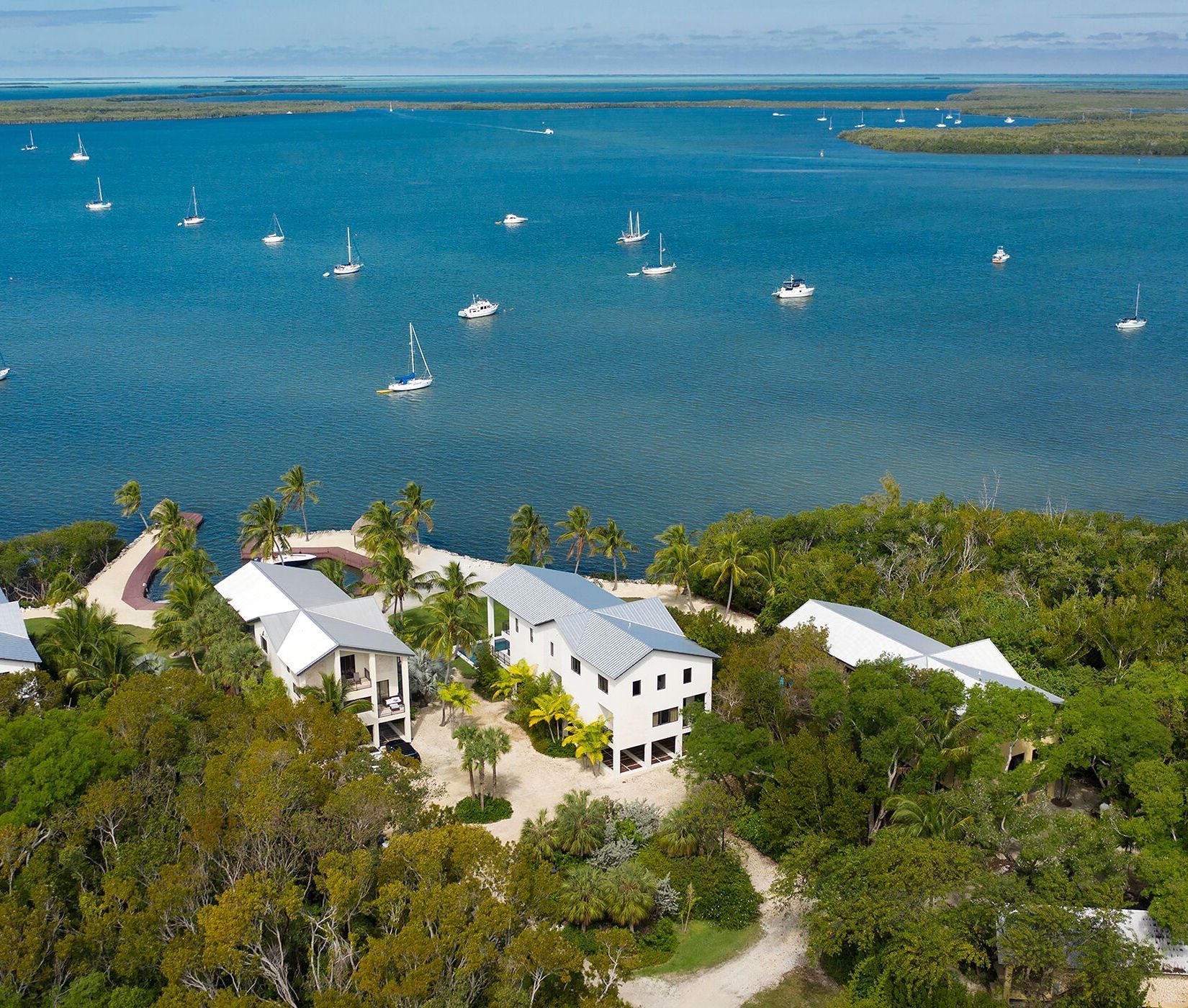 An aerial view of a house in the middle of a body of water