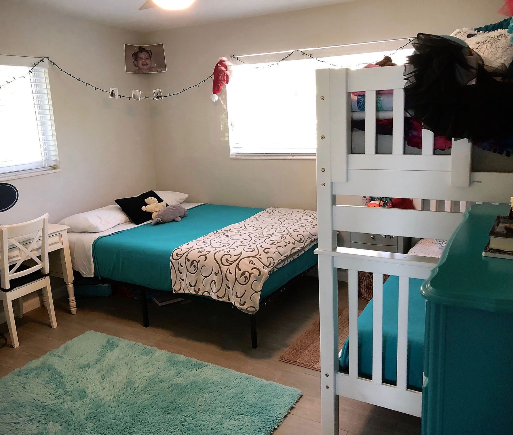 A bedroom with two beds and a bunk bed