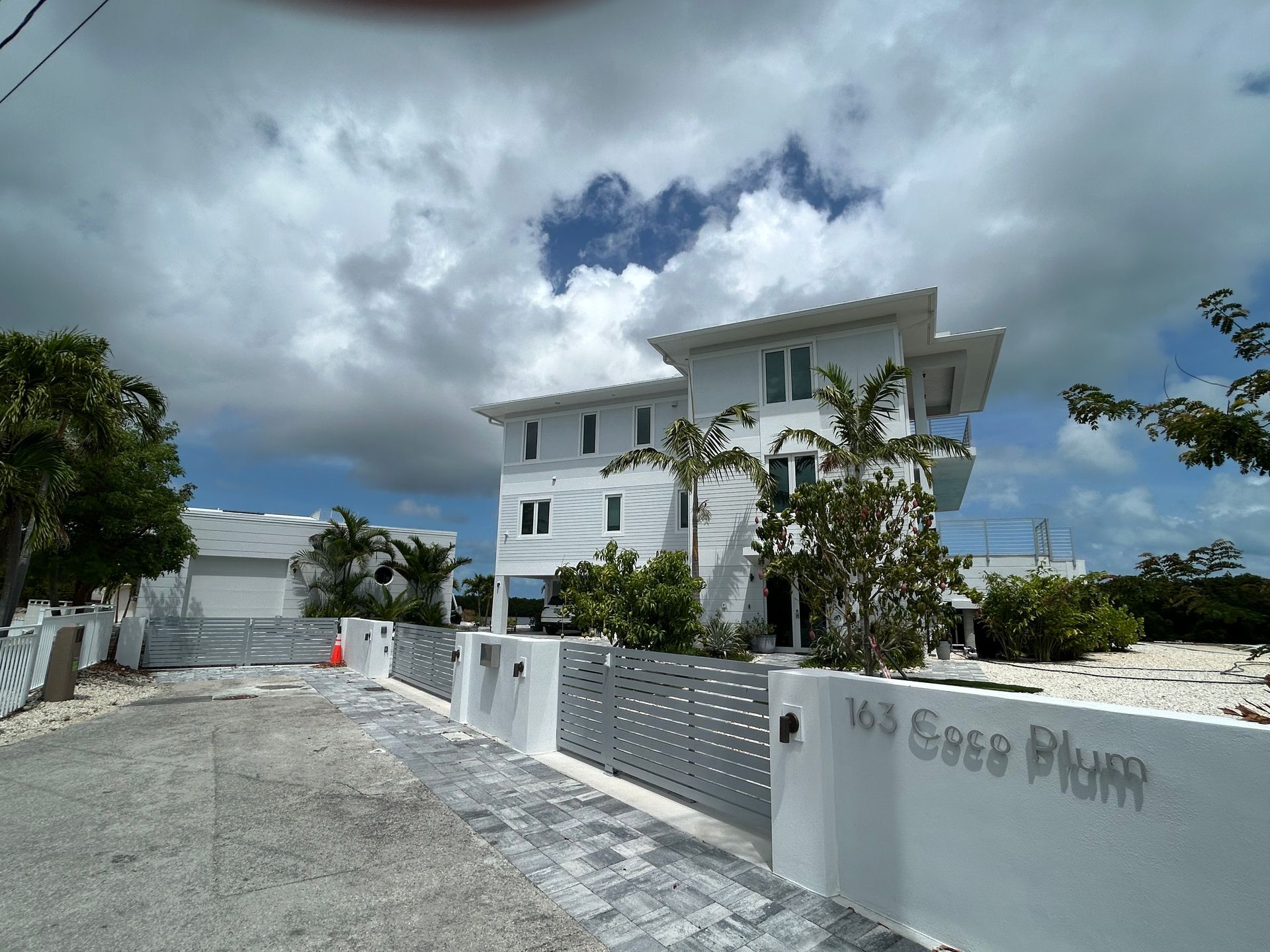 A large white house with a fence around it is for sale