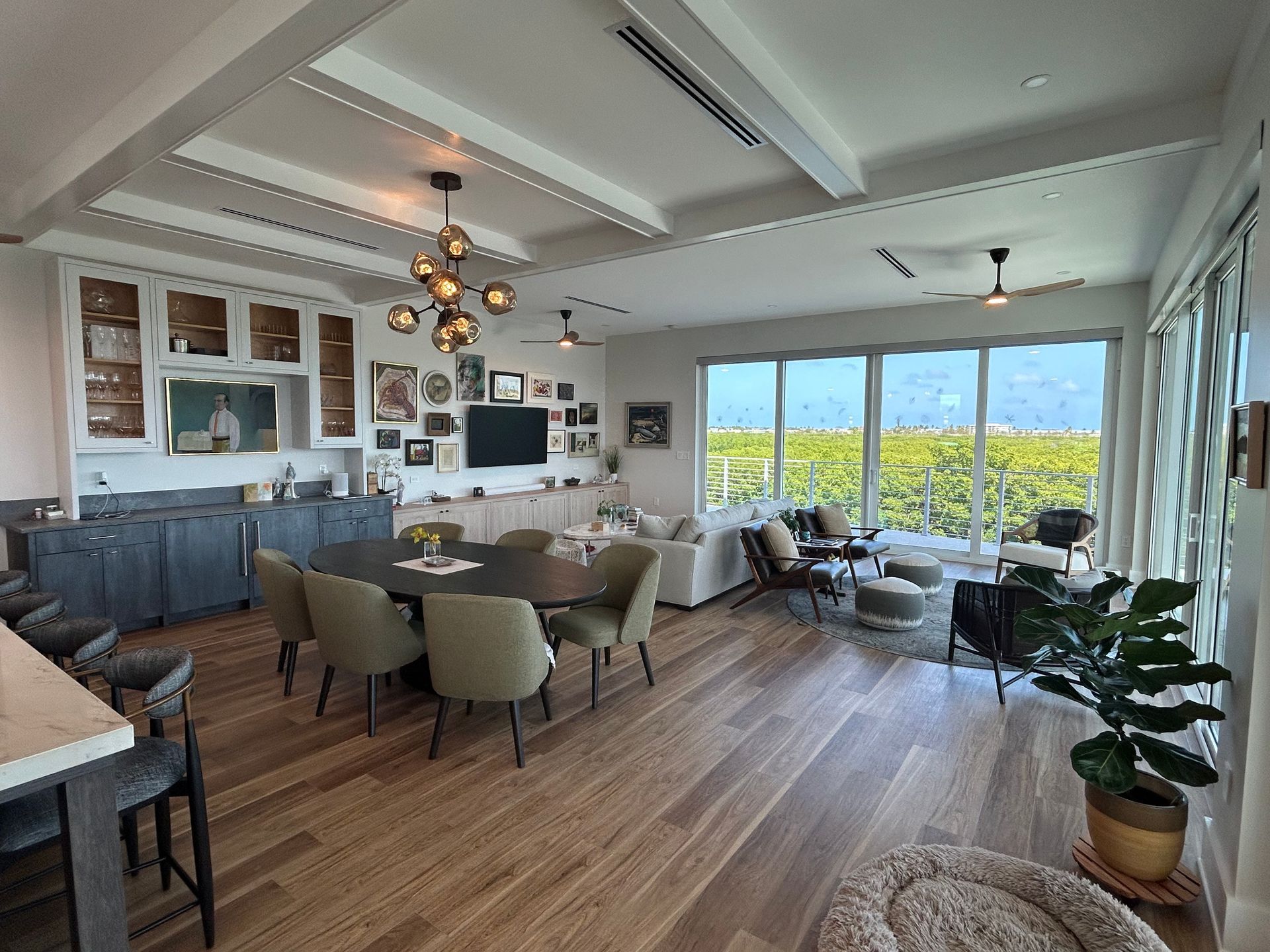 A living room with a table and chairs and a large window