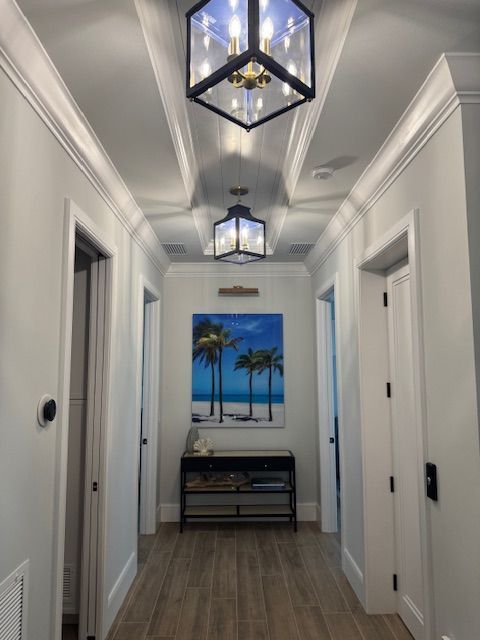 A hallway with a picture of palm trees on the wall