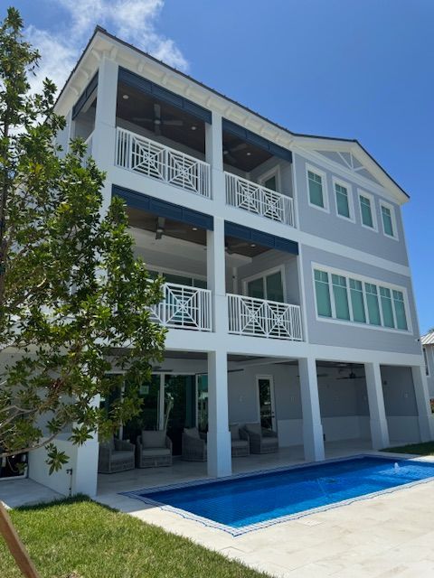 A large house with a swimming pool in front of it