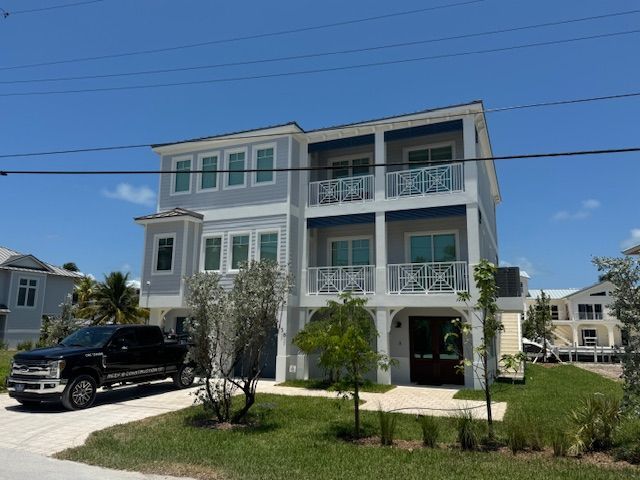 A large house with a black truck parked in front of it