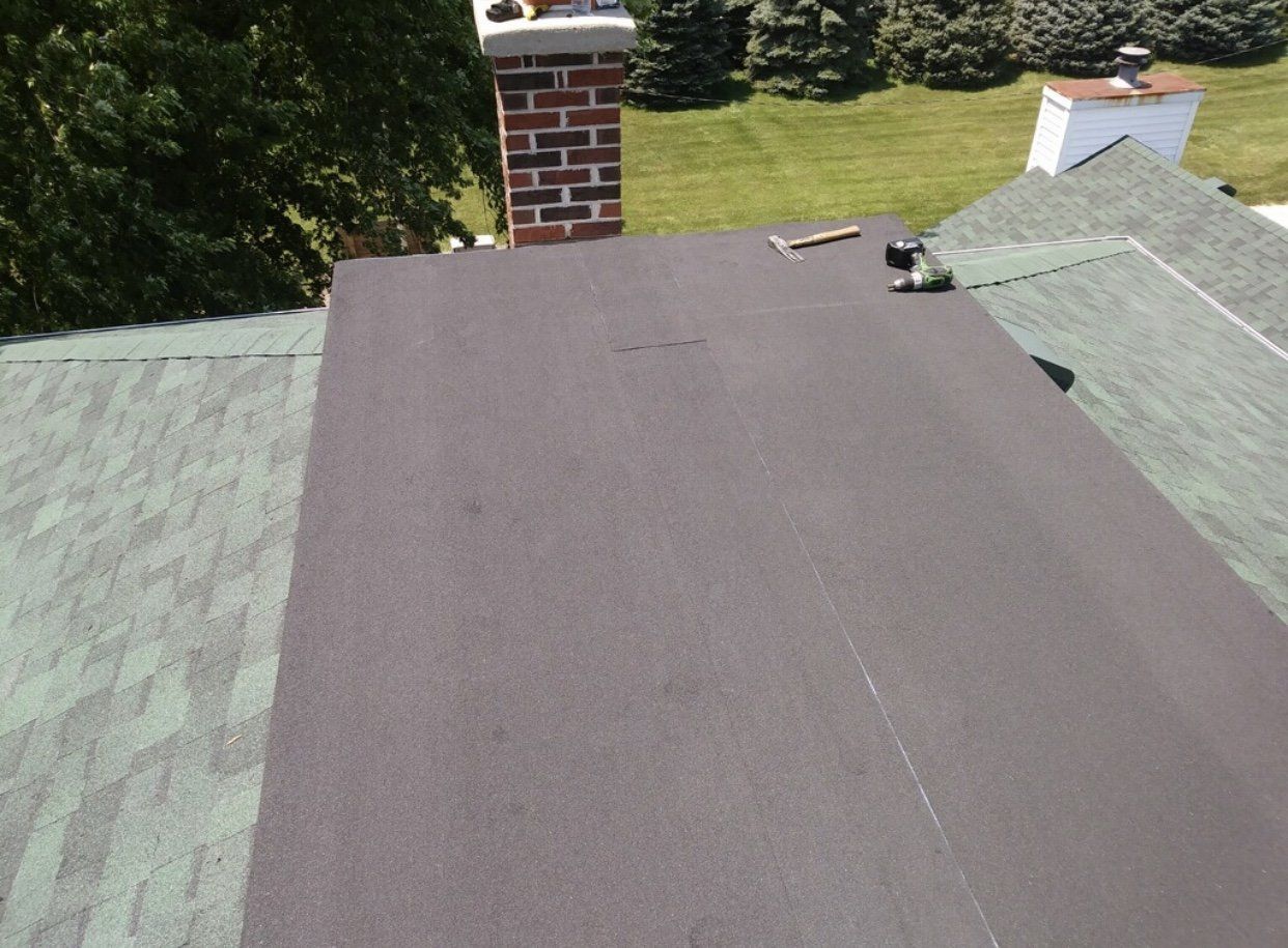 Flat Roof Installation With Construction Tools — Morris, IL — Shenberg Construction