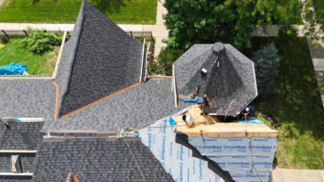 An aerial view of a roof being installed on a house.