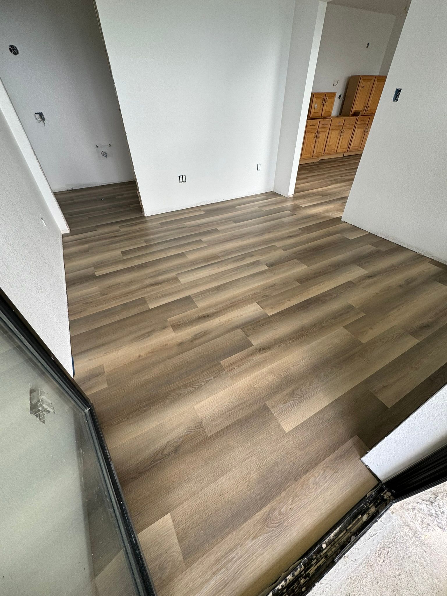 A room with a wooden floor and white walls.