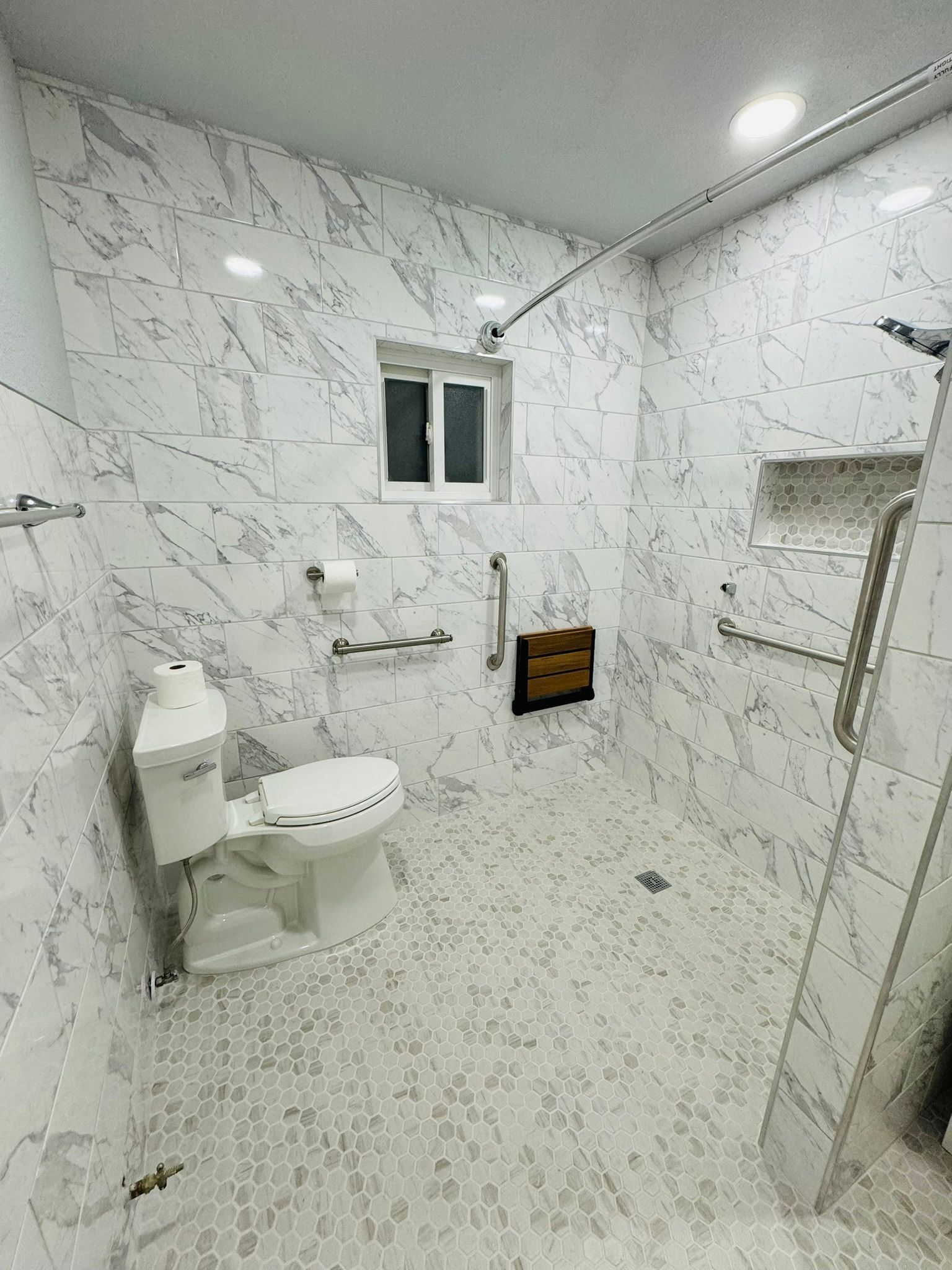 A bathroom with a toilet , shower , and window.