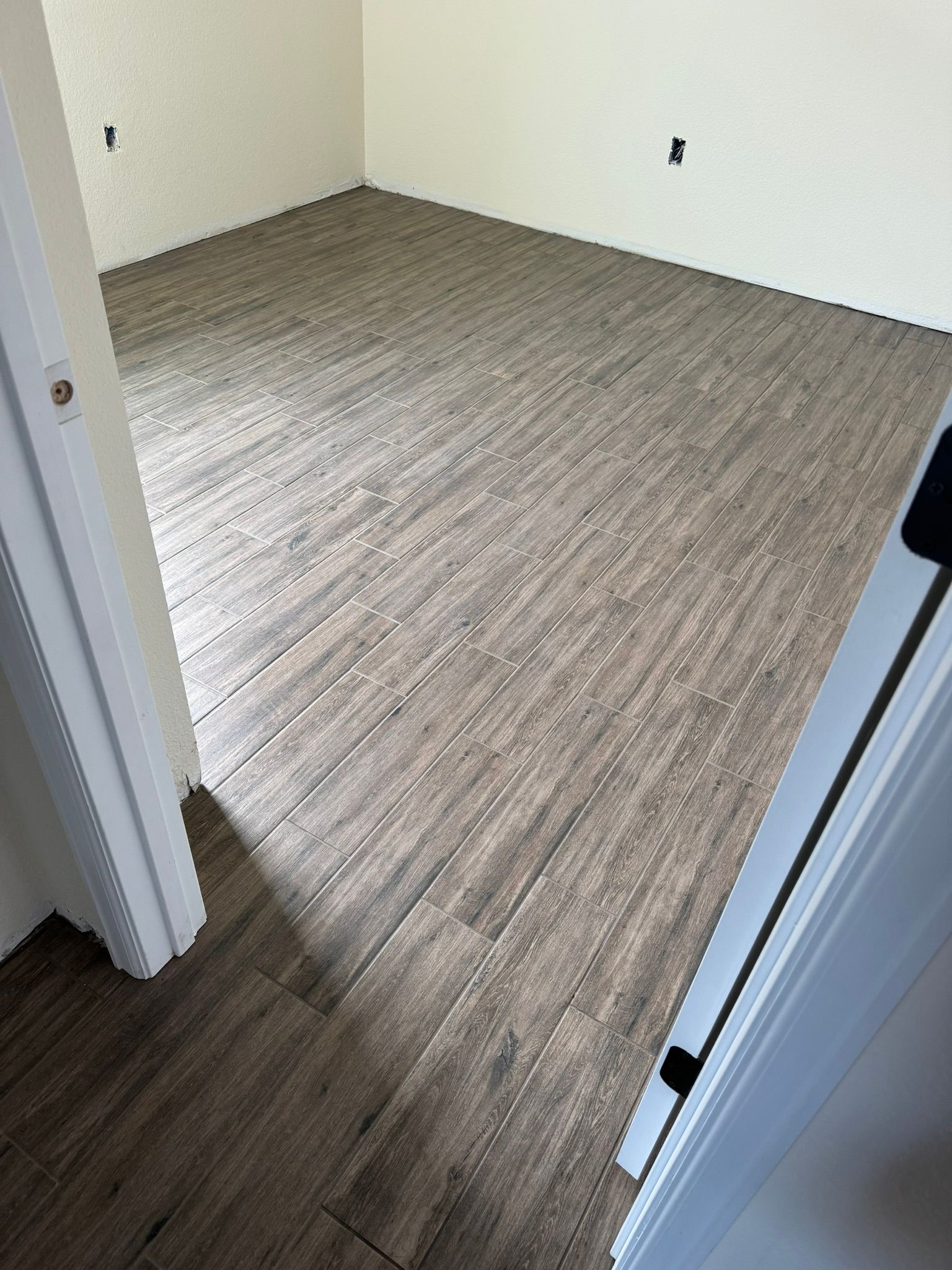 A room with a wooden floor and white walls.