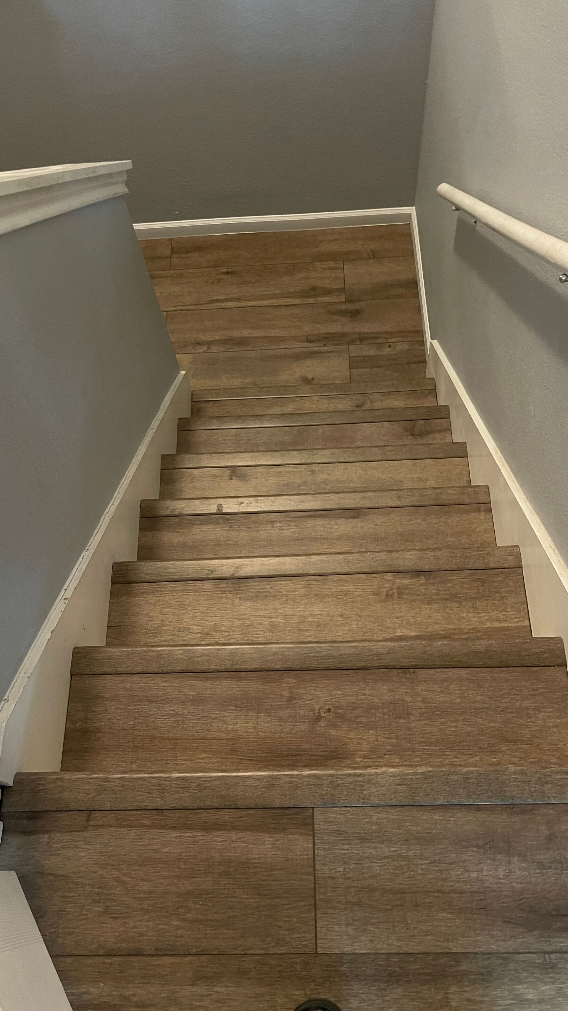 A set of wooden stairs leading up to the second floor of a house.