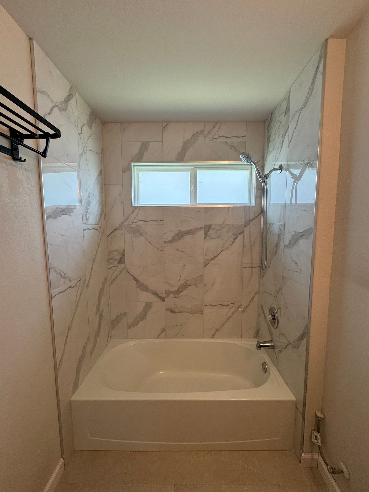 A bathroom with a bathtub and a shower.